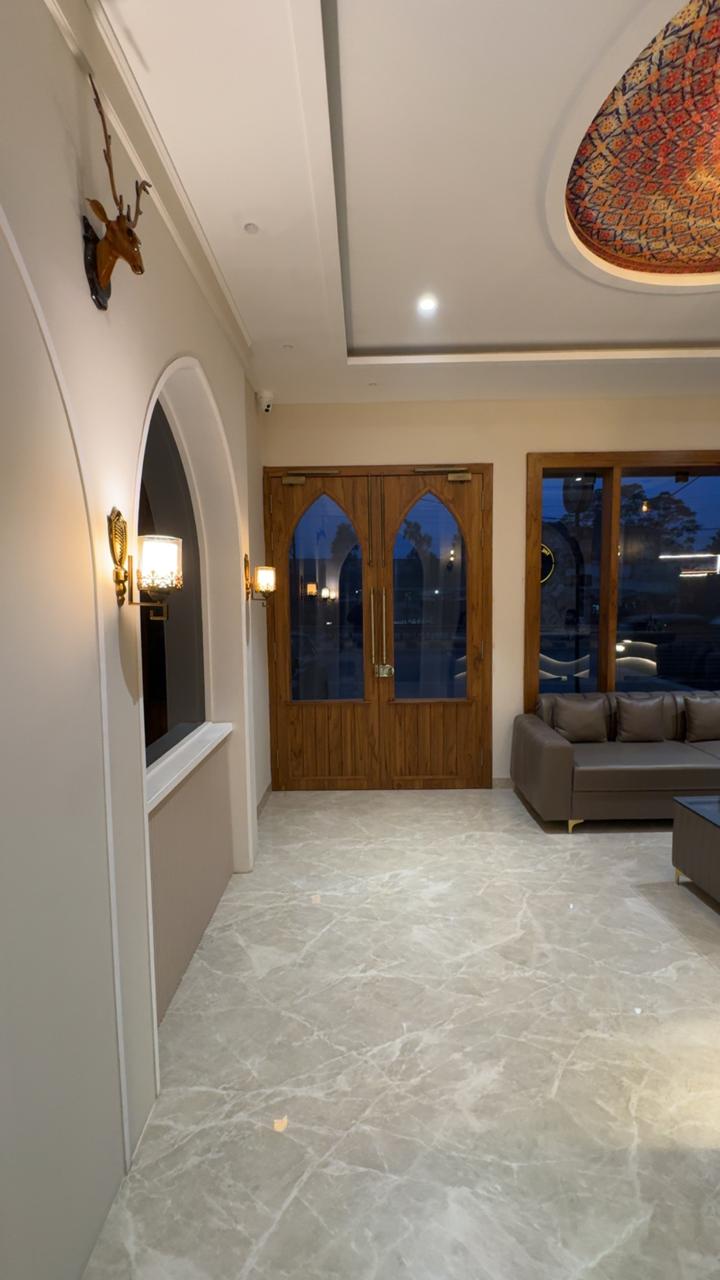 Grand lobby of THE ROYAL KING hotel Ludhiana with ornate chandelier and premium leather seating